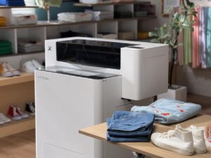 xTool Apparel Printer used for custom clothing production with t-shirts and denim apparel